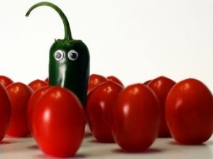 Funny hot pepper standing out in a crowd of peppers