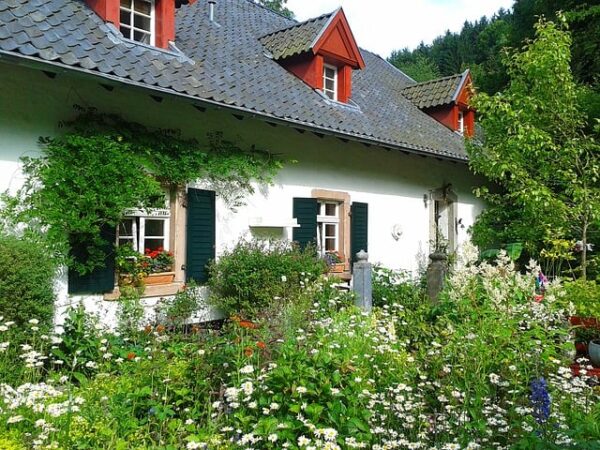 Cottage flower garden with white cottage